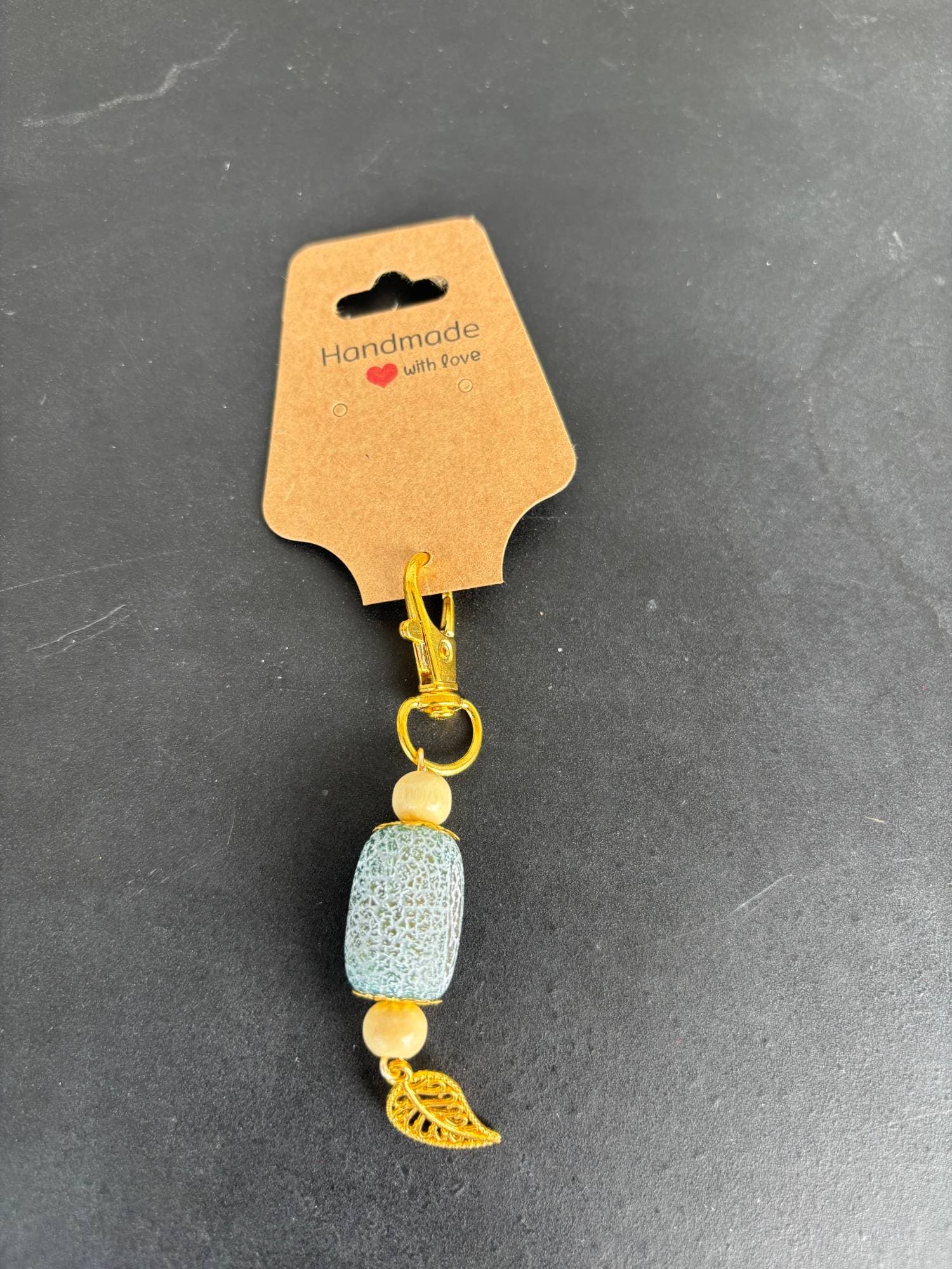 Frosted agate bead charm with a gold leaf