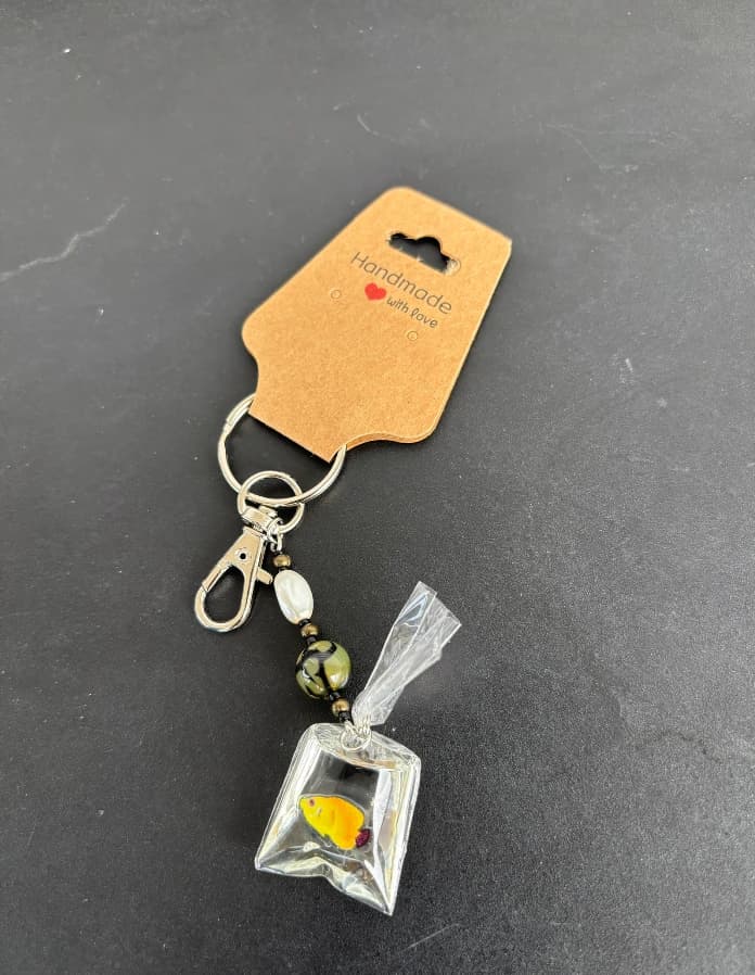 Playful little fish-in-a-bag charm