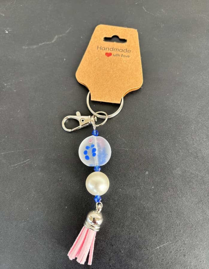 Frosted floral bead charm with a pink tassel