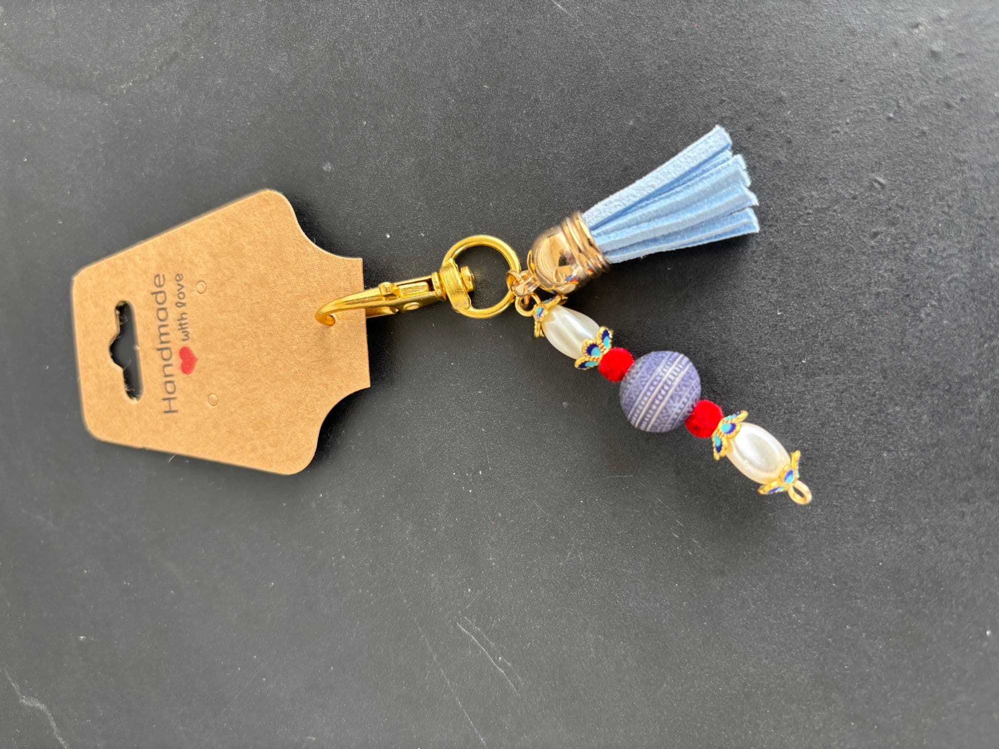 Sky-blue tassel charm with a pearl drop