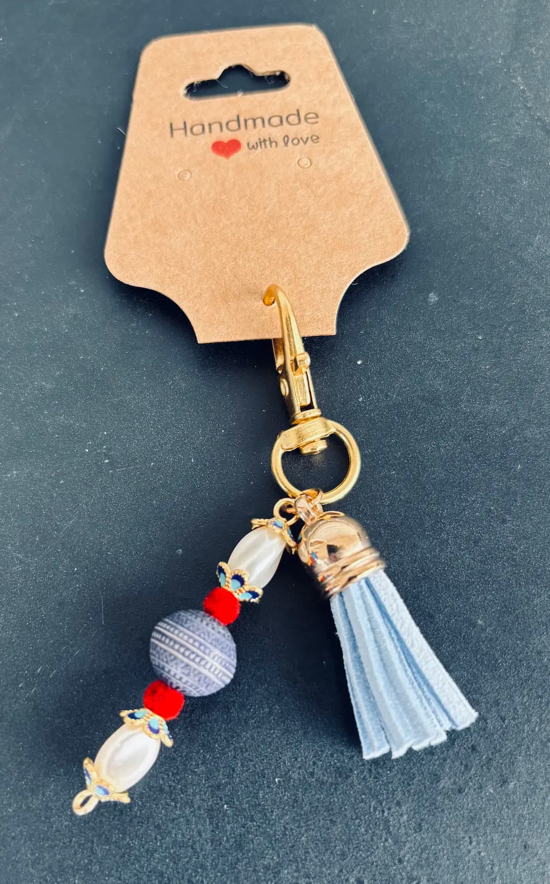 Sky-blue tassel charm with a pearl drop