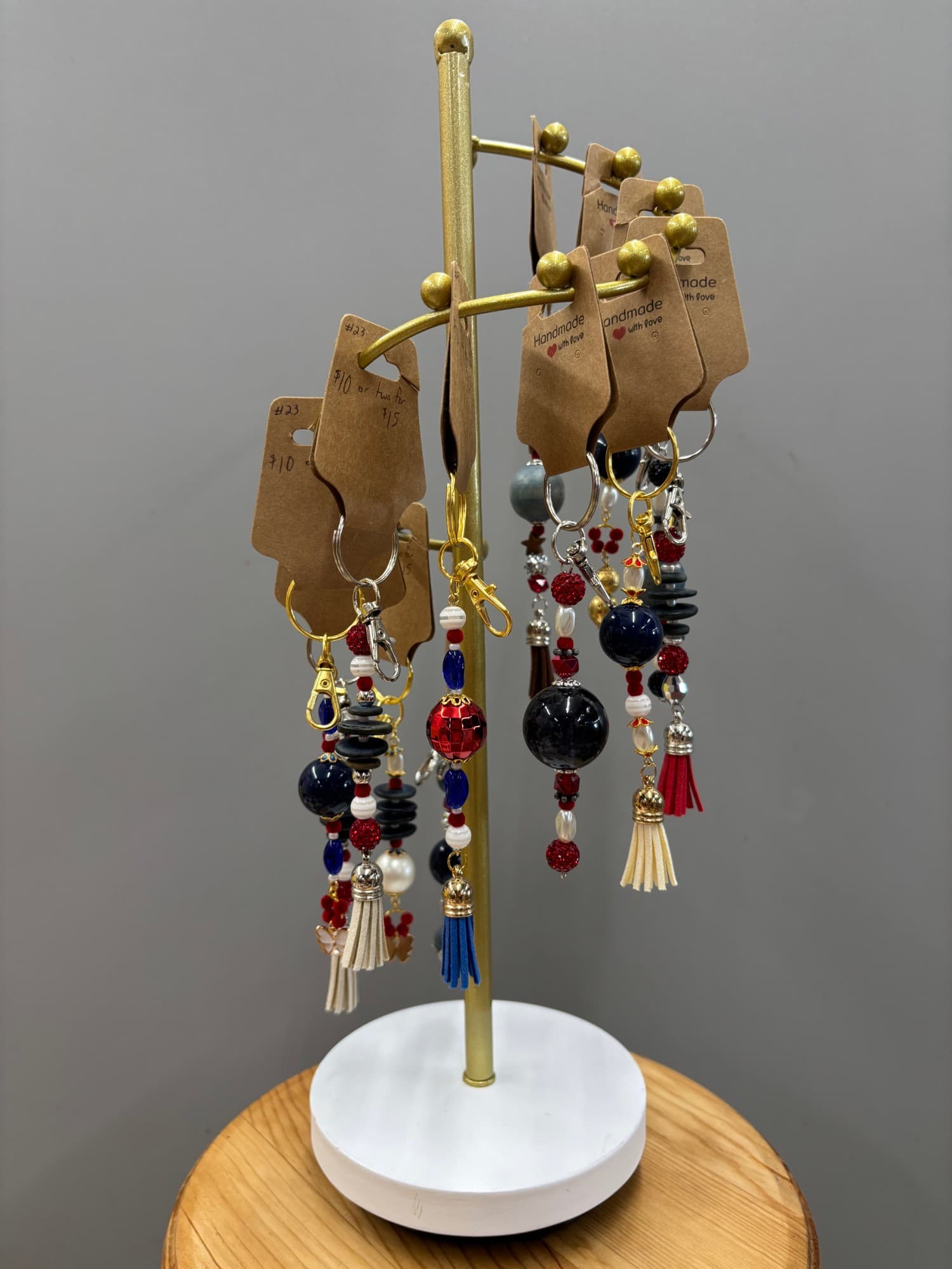 A gold display tree hung with beaded charms