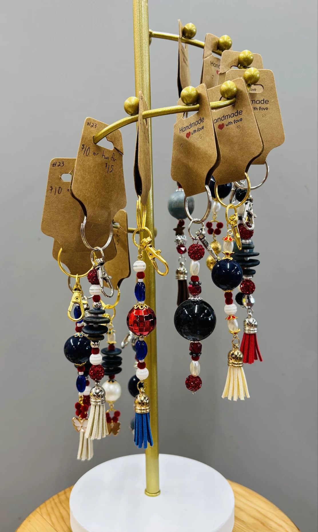 A gold display tree hung with beaded charms